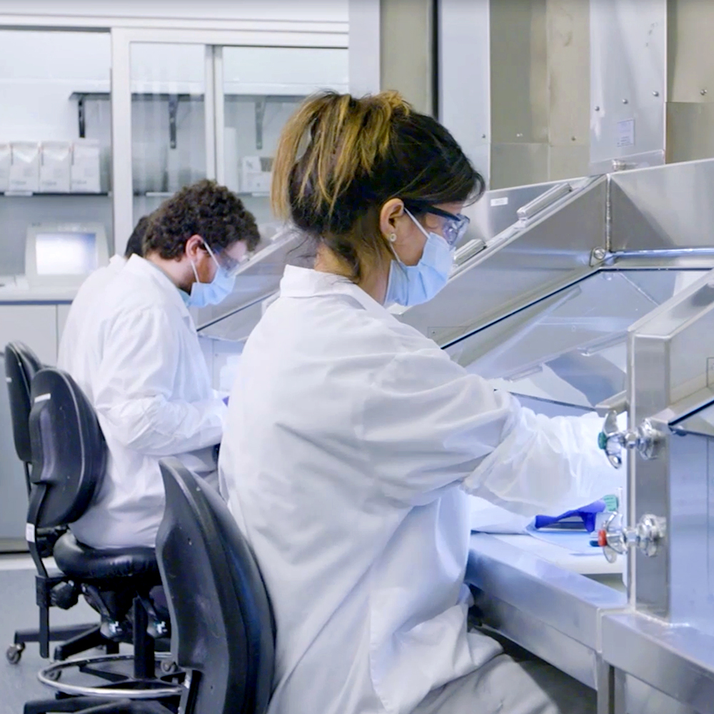 Biochemists using microscope while working on scientific research in a laboratory.
